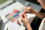 a woman applying press on nails