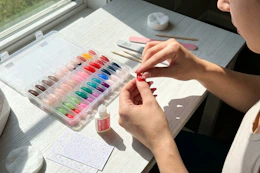 a woman applying press on nails
