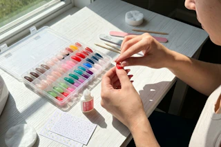 a woman applying press on nails