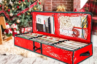 Lifestyle image of a red storage bag for Christmas Wrap underneath Christmas tree