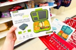 hand holding a bentgo pop lunchbox set over a target cart
