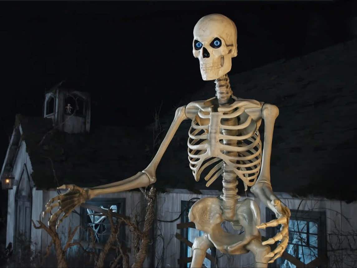 The giant skeleton from Home Depot on a spooky Halloween set