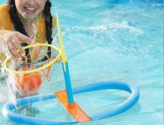 basketball ball hoop in a pool and a person throwing a ball in