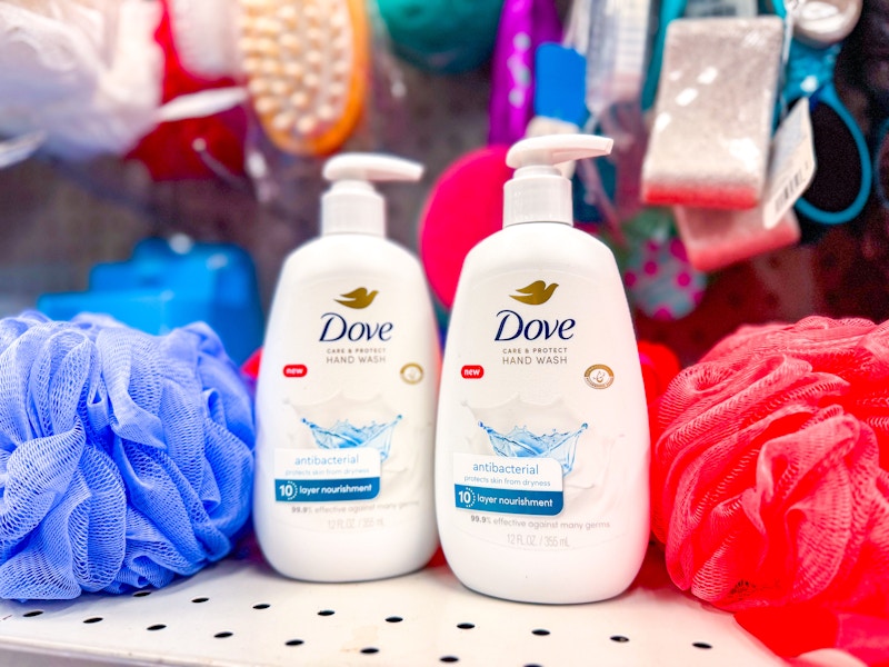 dove hand washes on a shelf by loofahs