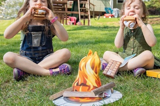 Two children playing with the Melissa and Doug campfire toy set
