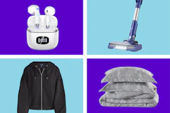white earbuds, black jacket, gray bedding, and stick vacuum