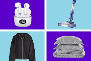 white earbuds, black jacket, gray bedding, and stick vacuum