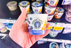 hand holding a cup of the greek gods yogurt