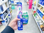hand holding crest and oral-b walgreens
