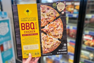 hand holding california pizza kitchen frozen pizza box