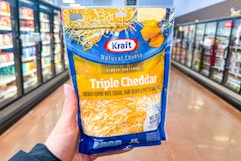 hand holding a bag of kraft cheese