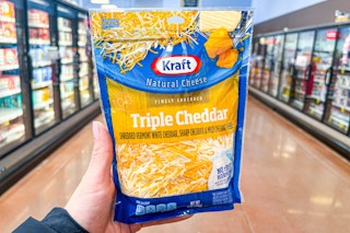 hand holding a bag of kraft cheese