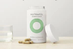 vitamins in a bottle and on a table with a cup of water