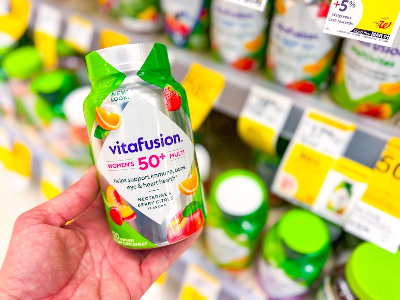 person holding a bottle of vitafusion multivitamins