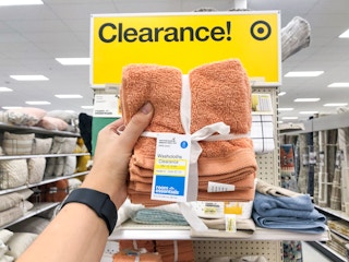 hand holding up 8-pack of washcloths on clearance in front of Target store shelf