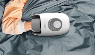 a person with their hand in a hand massager