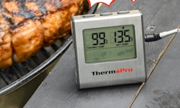 a digital thermometer next to a grill