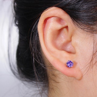 someones ear wearing an earring
