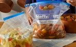 beef stew and chicken soup in Hefty bags on a counter