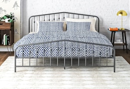 Lifestyle image of the king Novogratz Bushwick Metal Bed in Gunmetal Gray in a bedroom setting