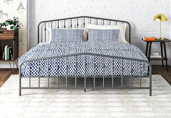 Lifestyle image of the king Novogratz Bushwick Metal Bed in Gunmetal Gray in a bedroom setting