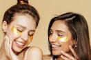 two women wearing gold under eye masks