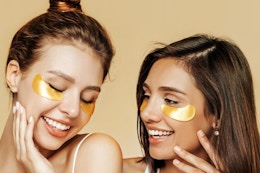 two women wearing gold under eye masks