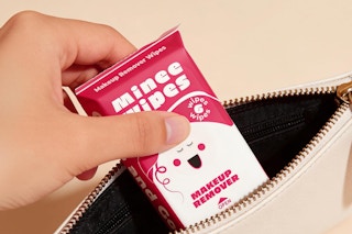 pack of travel makeup remover wipes being put in to purse