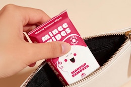 pack of travel makeup remover wipes being put in to purse