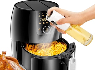 Oil sprayer spraying food in an air fryer