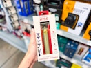 hand holding kiss hair trimmer set in walmart aisle