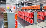 The inside of a Nike store with shelves of shoes