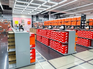 The inside of a Nike store with shelves of shoes