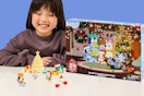 a girl next to a bluey advent calendar