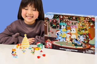 a girl next to a bluey advent calendar