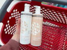 hand holding 2 purezero shampoo bottles over a target cart