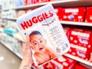 hand holding huggies snug & dry baby diapers pack at target