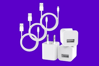 iPhone charging cords and blocks on a purple background