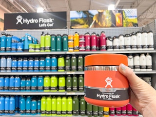 hydro flasks on store shelf wtih one being held