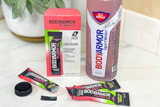 bodyarmor flash iv drink mix packets next to a body armor sport water bottle