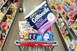 cottonelle toilet paper, cinnamon toast crunch cereal, crest toothpaste, ogx shampoo, and persil detergent in a cart