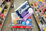 cottonelle toilet paper, cinnamon toast crunch cereal, crest toothpaste, ogx shampoo, and persil detergent in a cart
