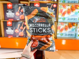 hand holding a bag of petite cuisine mozzarella sticks