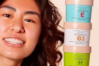 a girl holding up a few containers of the Sephora Collection Vitamin Mask