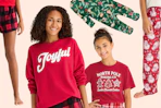 Festive pajama items (shorts, pants, sweater, tee, onesie) all in a Christmas theme