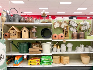 A variety of outdoor decor sitting on store shelves.