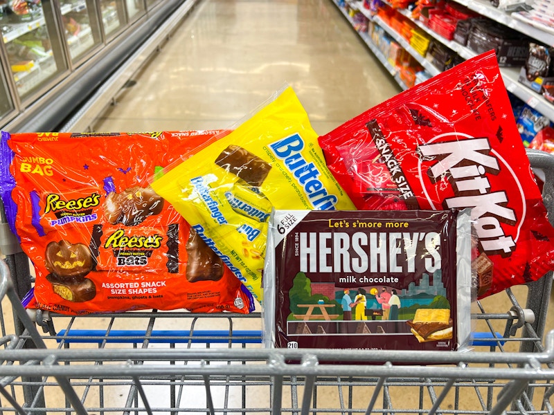 reeses pumpkins, butterfinger, hersheys and kit kats in a cart