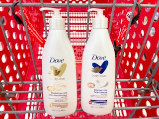 Two bottles of Dove Body Love lotions sitting in a store cart.