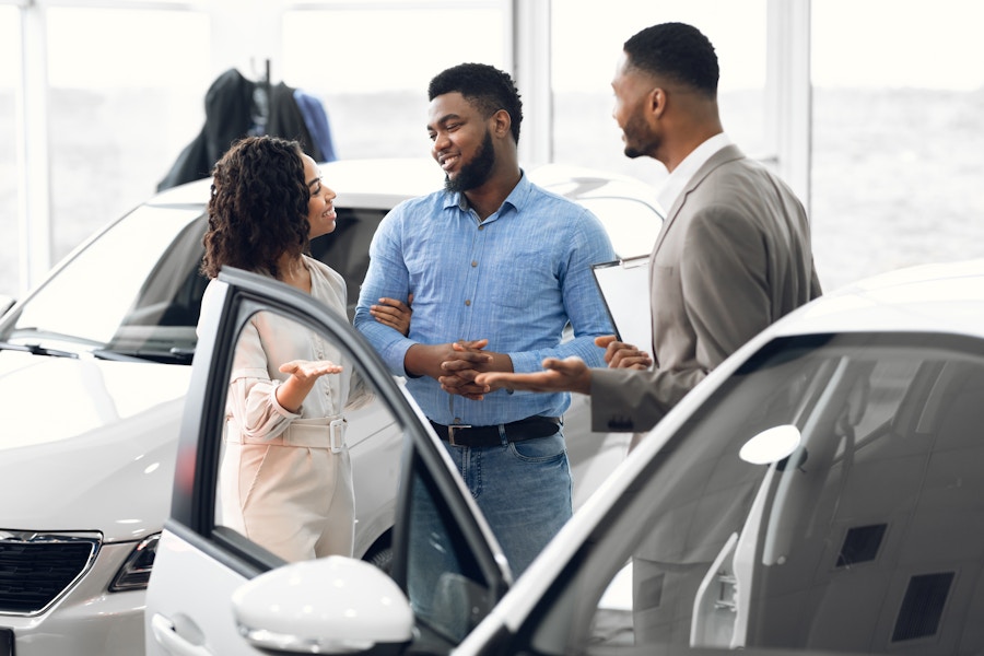 A couple looking to buy a vehicle in a dealership