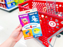 holding a chuckle & roar kids' card game 4-pack in front target cart